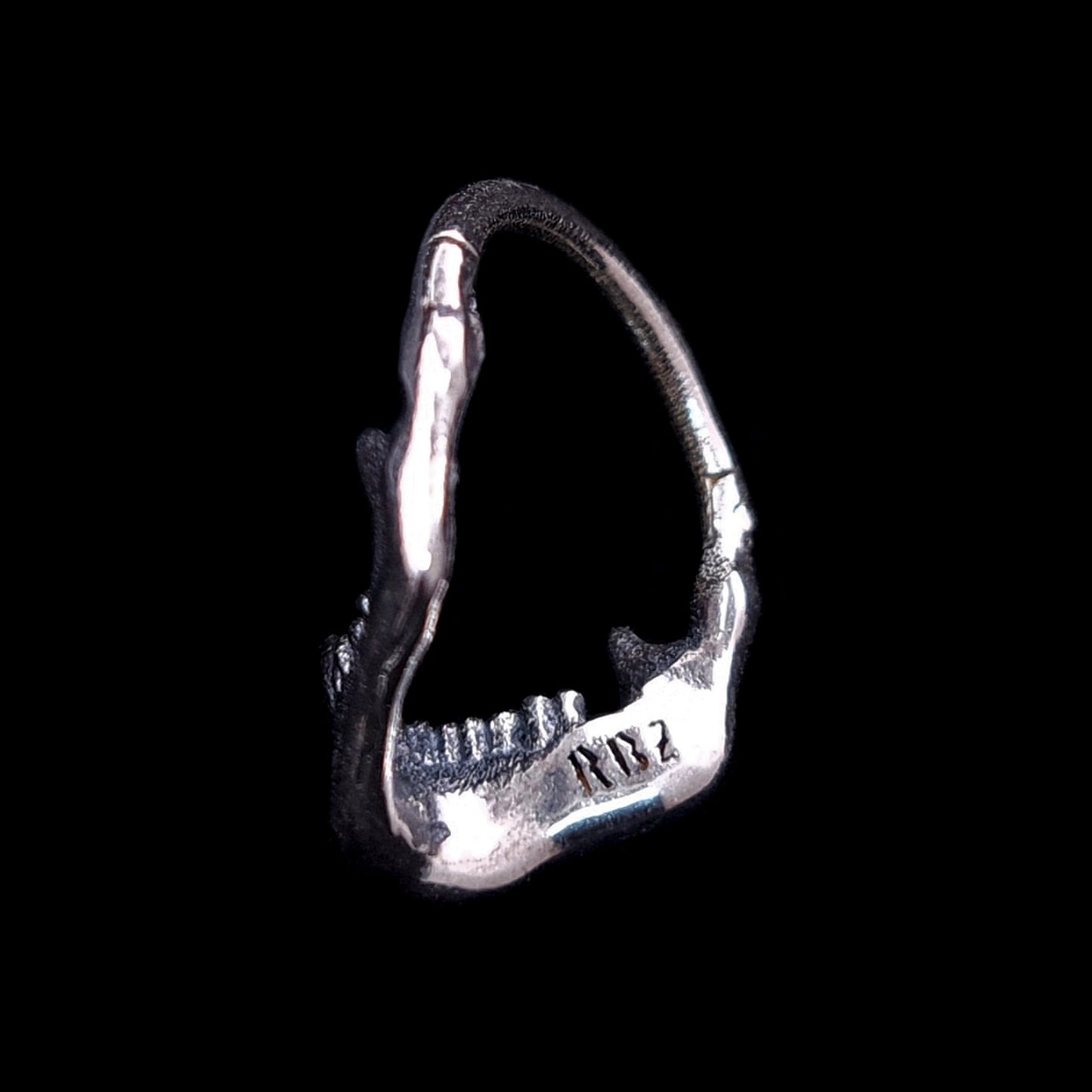 Back view of the Sterling silver Reaped Mandible clicker septum ring by RBZ Jewelry, showcasing the handcrafted interior with the signature RBZ logo engraving on the oxidized gothic skull jaw design.