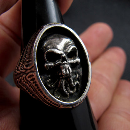 RBZ Jewelry Sterling Silver Tentacle Skull Signet Ring displayed on a black ring stand, showcasing the high-relief gothic skull and Cthulhu-inspired tentacles in a real-world scale perspective.