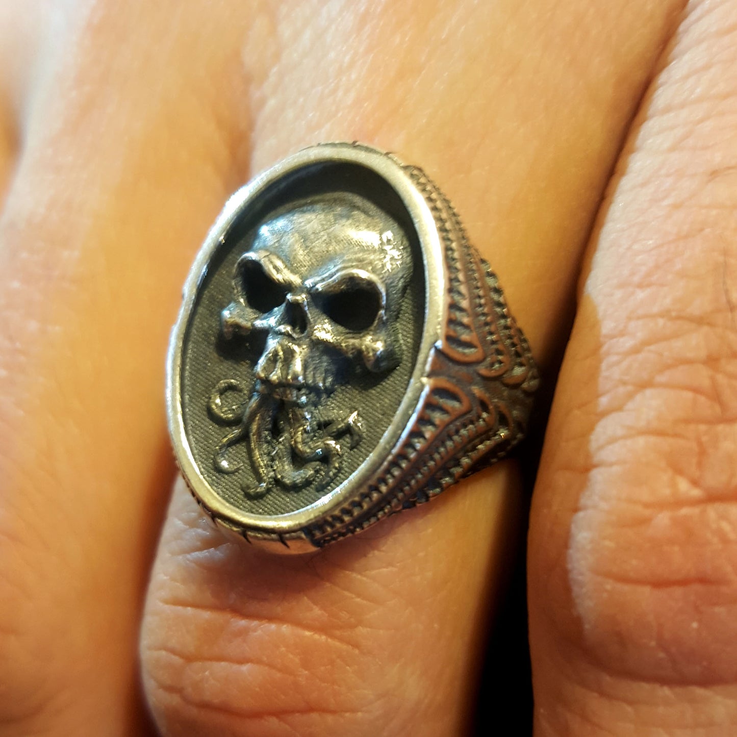 RBZ Jewelry Sterling Silver Tentacle Skull Signet Ring shown being worn on a finger, demonstrating the scale and fit of the high-relief gothic skull and Cthulhu-inspired design.