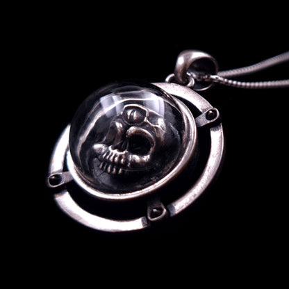 RBZ Jewelry handcrafted sterling silver Third-eye Skull pendant featuring an anatomical three-eyed skull encased in a protective clear glass dome, set within a riveted circular silver frame on a dark background.