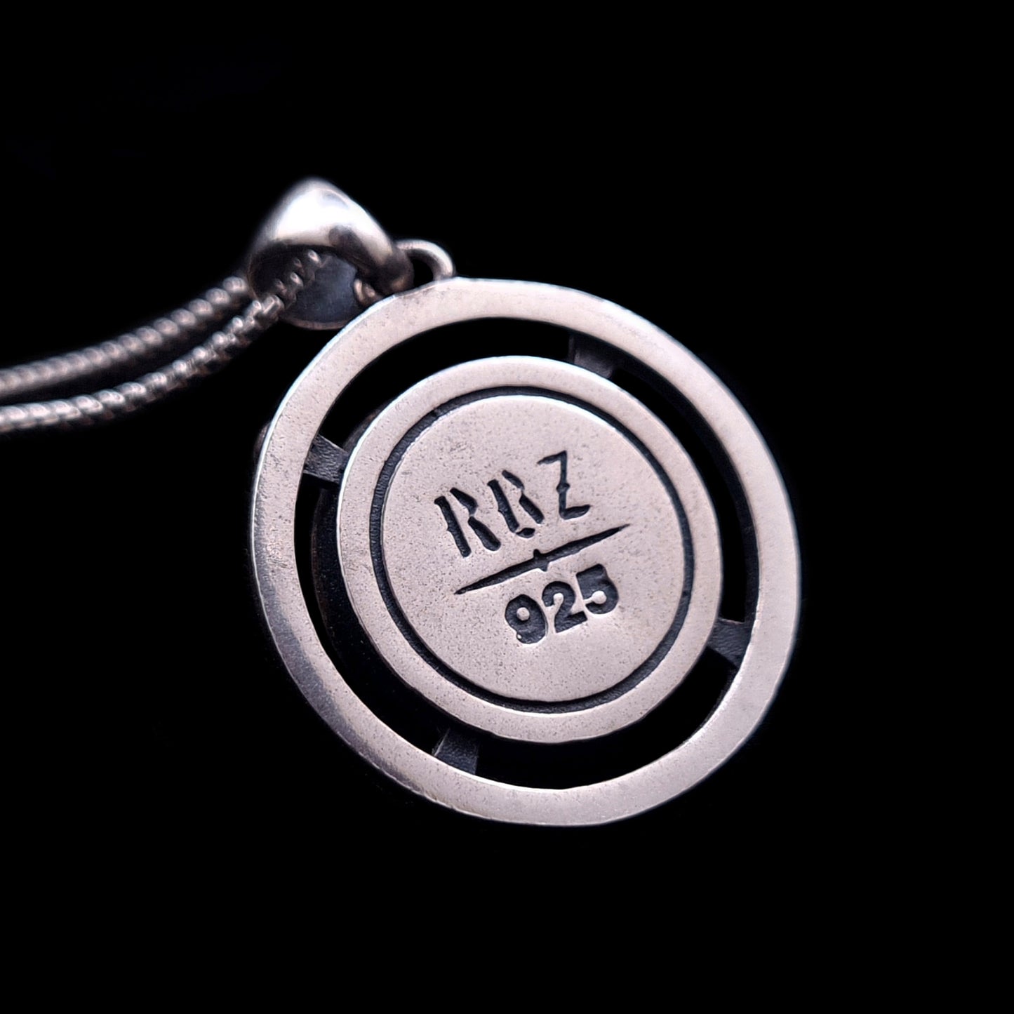 Back view of the RBZ Jewelry Third-eye Skull pendant in sterling silver, featuring the engraved RBZ brand logo and 925 hallmark on a flat circular base with a double-ring frame.
