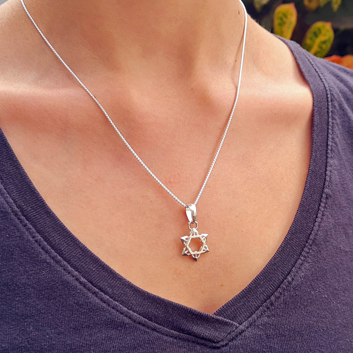 Sterling Silver Industrial Star of David Pendant by RBZ Jewelry worn by a female model, highlighting the shuriken-inspired 3D geometric design and contemporary urban aesthetic.