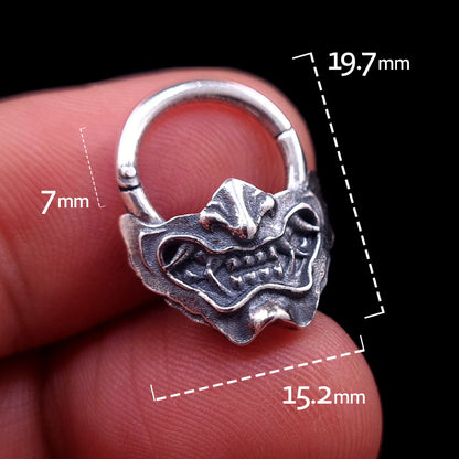 Sterling silver Samurai Oni mask septum ring by RBZ Jewelry, held in hand with overlaid dimensions showing a 7mm inner drop, 19.7mm total height, and 15.2mm width.