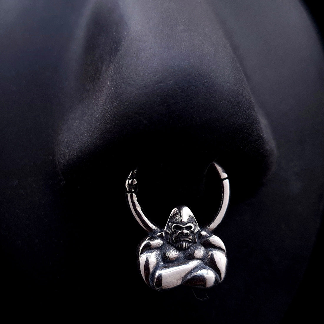 Sterling silver Jungle Gorilla septum clicker ring by RBZ Jewelry shown worn on a life-size black silicone nose display, illustrating the placement and fit of the detailed gorilla bust design.