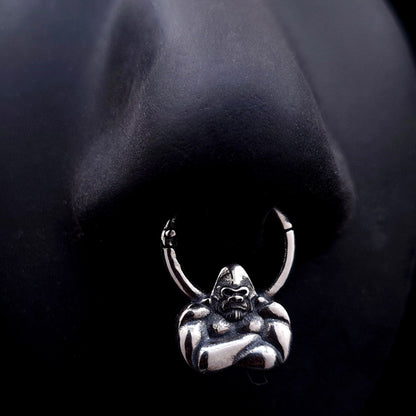 Sterling silver Jungle Gorilla septum clicker ring by RBZ Jewelry shown worn on a life-size black silicone nose display, illustrating the placement and fit of the detailed gorilla bust design.