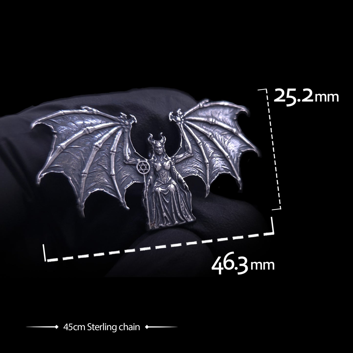 Product dimensions view of the RBZ Jewelry Gothic Sterling silver Lilith Demon Angel pendant held in a black-gloved hand. Text overlay shows precise measurements: 25.2 mm height and 46.3 mm width across the skeletal bat wings, with a label indicating a 45cm Sterling silver chain included.