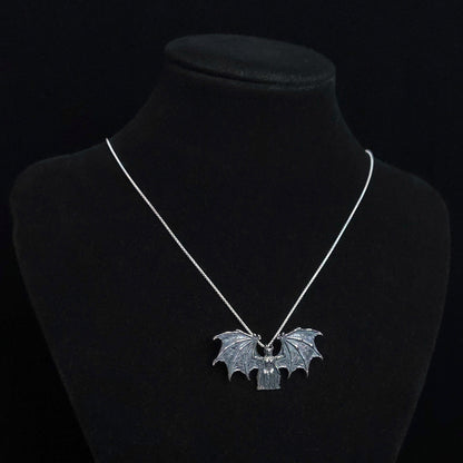 RBZ Jewelry Gothic Judaica Sterling silver Lilith Demon Angel pendant with skeletal bat wings, displayed on a black mannequin bust to show scale and drape on a silver chain.