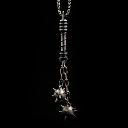 Sterling silver flail crusher pendant by RBZ Jewelry featuring two sharp spiked spheres hanging from chains and a detailed spiral-textured handle in a gothic medieval style.