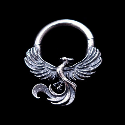 Detailed sterling silver Soaring Phoenix septum clicker ring by RBZ Jewelry, featuring an intricately carved phoenix with outstretched wings and a curved tail, captured in a moment of ascent against a solid black background.