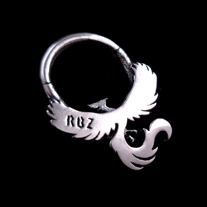 Back view of the sterling silver Soaring Phoenix septum ring by RBZ Jewelry, showing the smooth polished finish and the official RBZ maker's mark stamped on the wing, isolated on a black background.