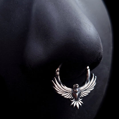Sterling silver Tribal Eagle septum ring by RBZ Jewelry worn on a black silicone nose model, demonstrating the fit and scale of the gothic eagle design with its outstretched wings.
