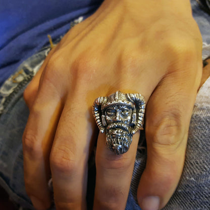 Sterling silver Viking warrior ring by RBZ Jewelry shown on a male hand, highlighting the large, hand-sculpted warrior face and horned helmet in a lifestyle shot against a denim background.