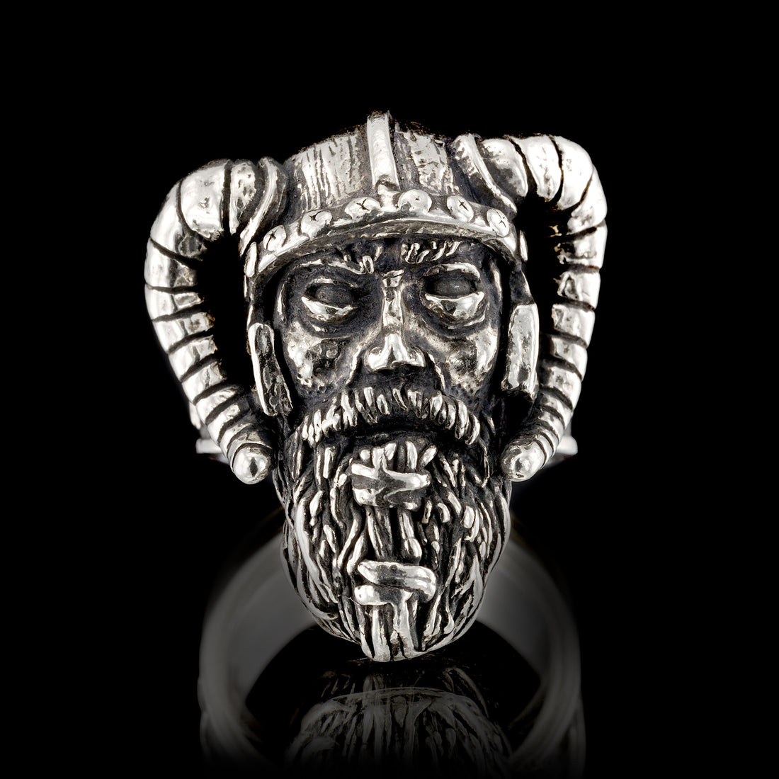 Full frontal view of the Sterling silver Viking warrior ring by RBZ Jewelry, showcasing the hand-sculpted weathered warrior face and detailed horned helmet on a black reflective background.