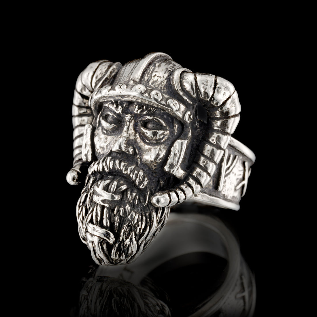 Sterling silver Viking warrior ring by RBZ Jewelry, featuring an intricately hand-sculpted warrior face with a detailed beard and a curved horned helmet, presented in a front view on a black reflective background.