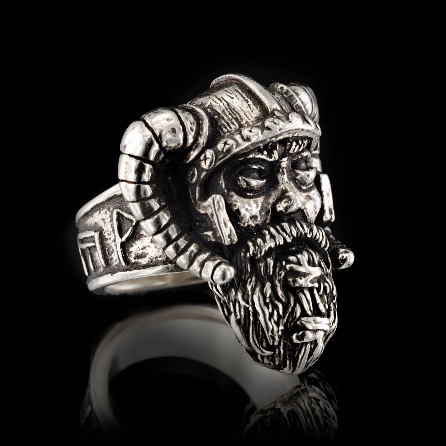 Side profile of the RBZ Jewelry Sterling silver Viking Warrior ring facing right, highlighting the weathered warrior face, horned helmet, and the runic band featuring the Axe-Hammer and prosperity symbols.