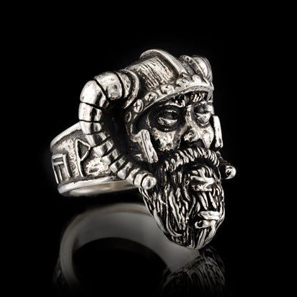 Side profile of the RBZ Jewelry Sterling silver Viking Warrior ring facing right, highlighting the weathered warrior face, horned helmet, and the runic band featuring the Axe-Hammer and prosperity symbols.