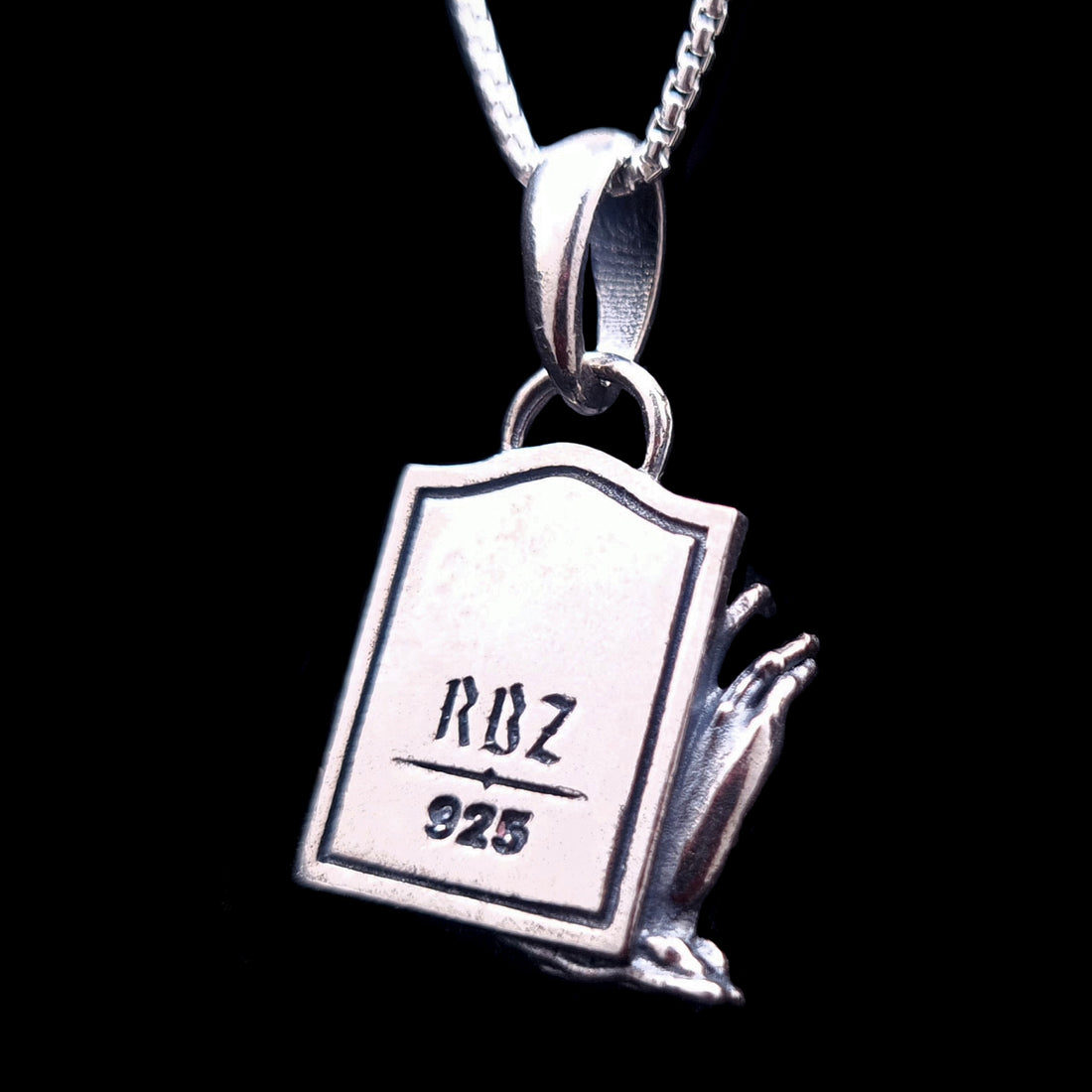 Back view of the sterling silver Zombie Star of David pendant, featuring a tombstone shape engraved with the RBZ Jewelry logo and the 925 sterling silver hallmark. The detailed decaying zombie hand is visible from the side, emphasizing the gothic craftsmanship of the piece.