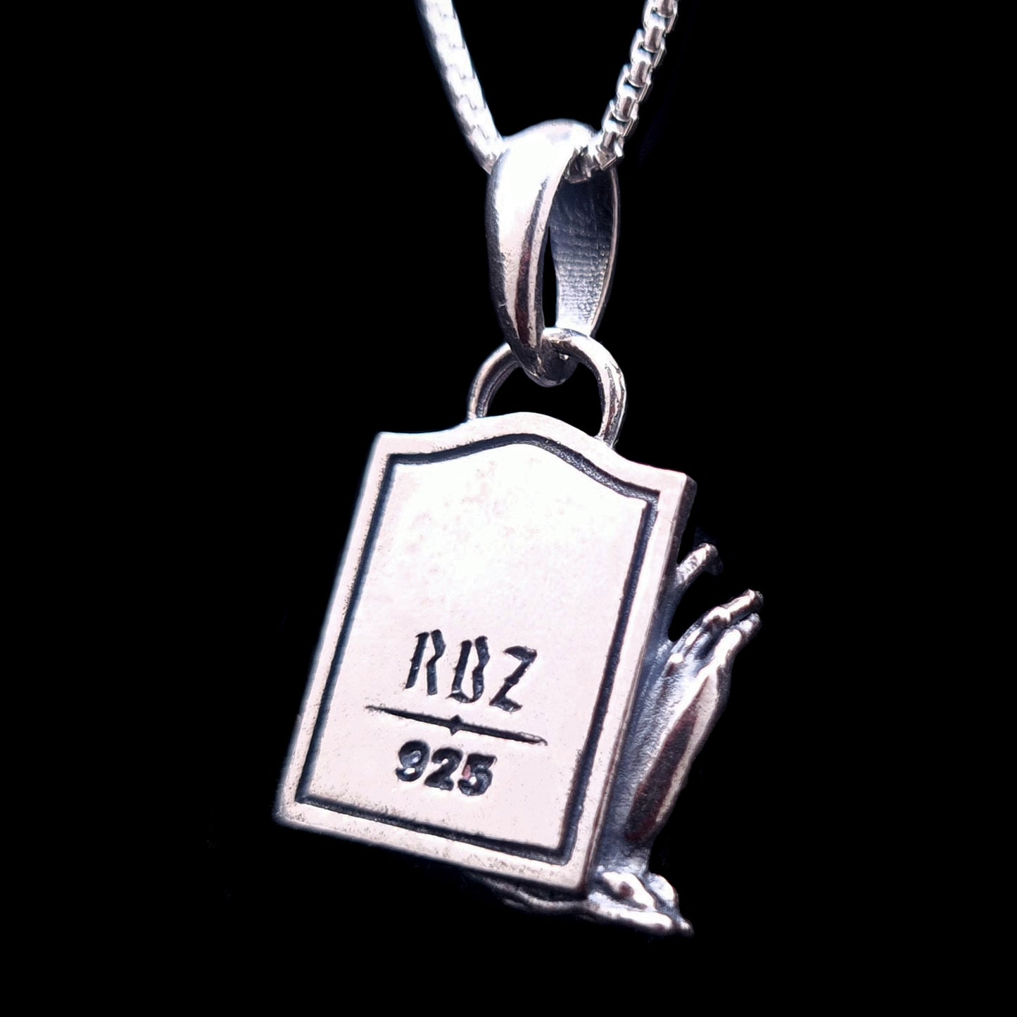 Back view of the sterling silver Zombie Star of David pendant, featuring a tombstone shape engraved with the RBZ Jewelry logo and the 925 sterling silver hallmark. The detailed decaying zombie hand is visible from the side, emphasizing the gothic craftsmanship of the piece.