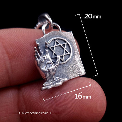 Sterling silver Gothic Zombie Star of David pendant held between fingers to demonstrate scale. Graphic overlays show dimensions of 20mm height and 16mm width, with a 45cm sterling silver chain. The pendant features a detailed zombie hand beside a tombstone with a Magen David symbol.